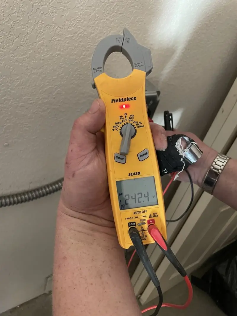 Voltage testing with clamp meter during Electrical Installation Services in Laconia